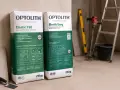 Dwa worki kleju Optolith Elastic T60 i Elastic Easy. Idealny klej do płytek na ogrzewanie podłogowe, zapewniający doskonałą przyczepność.